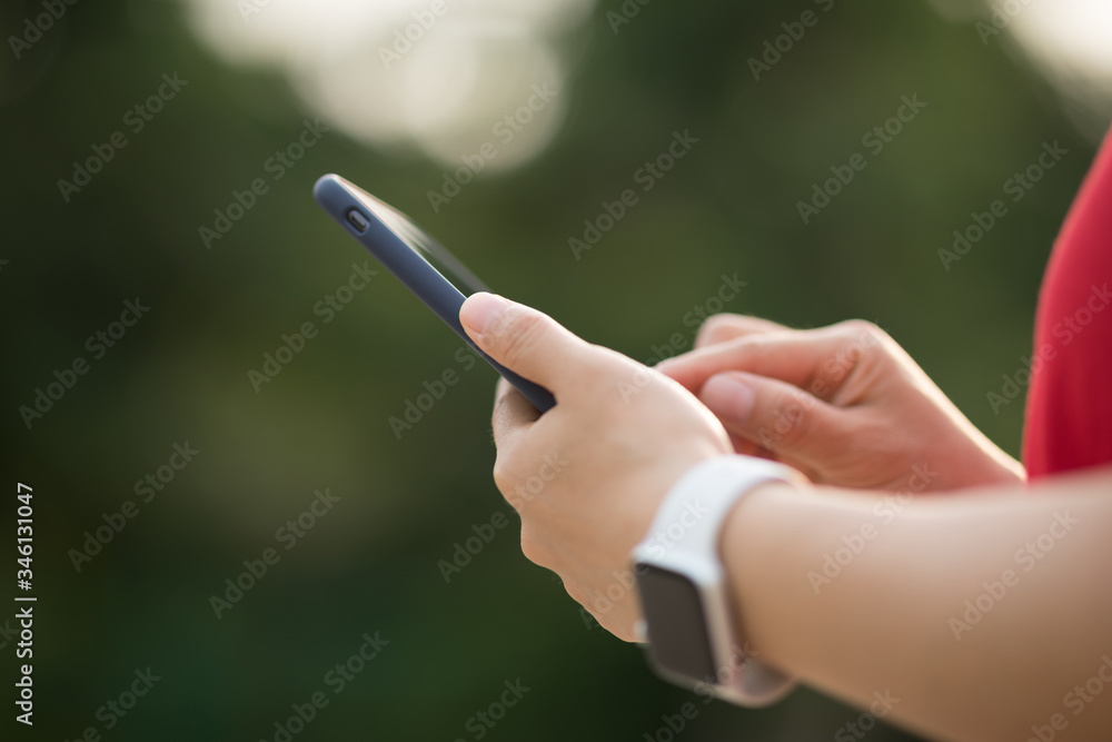 Asian woman using smartphone outdoors. Asian woman using smartphone outdoors.