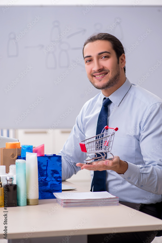 Young male shopaholic in e-commerce concept Young male shopaholic in e-commerce concept