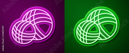 Glowing neon line Yarn ball icon isolated on purple and green background. Label for hand made, knitting or tailor shop. Vector Illustration