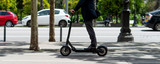 man on electric scooter through the city