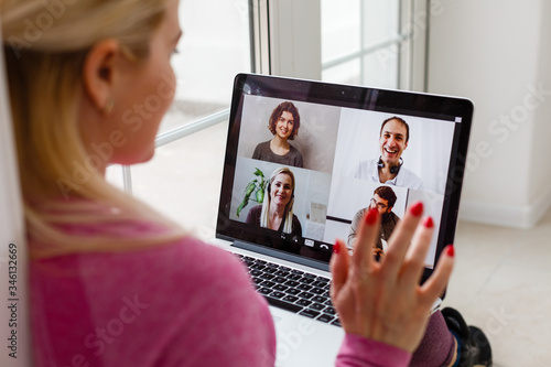 Woman Working From Home Having Group Videoconference On Laptop