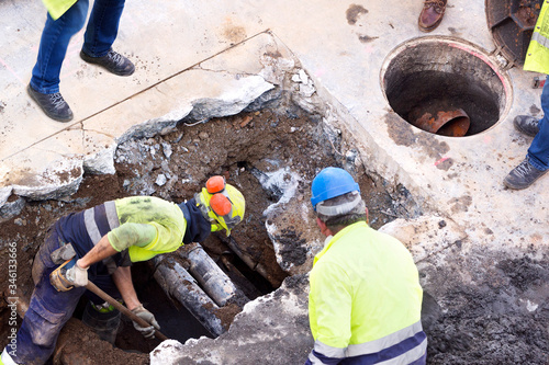 sewer  utility worker for cleaning and repairing sewerage pipes  in construction site