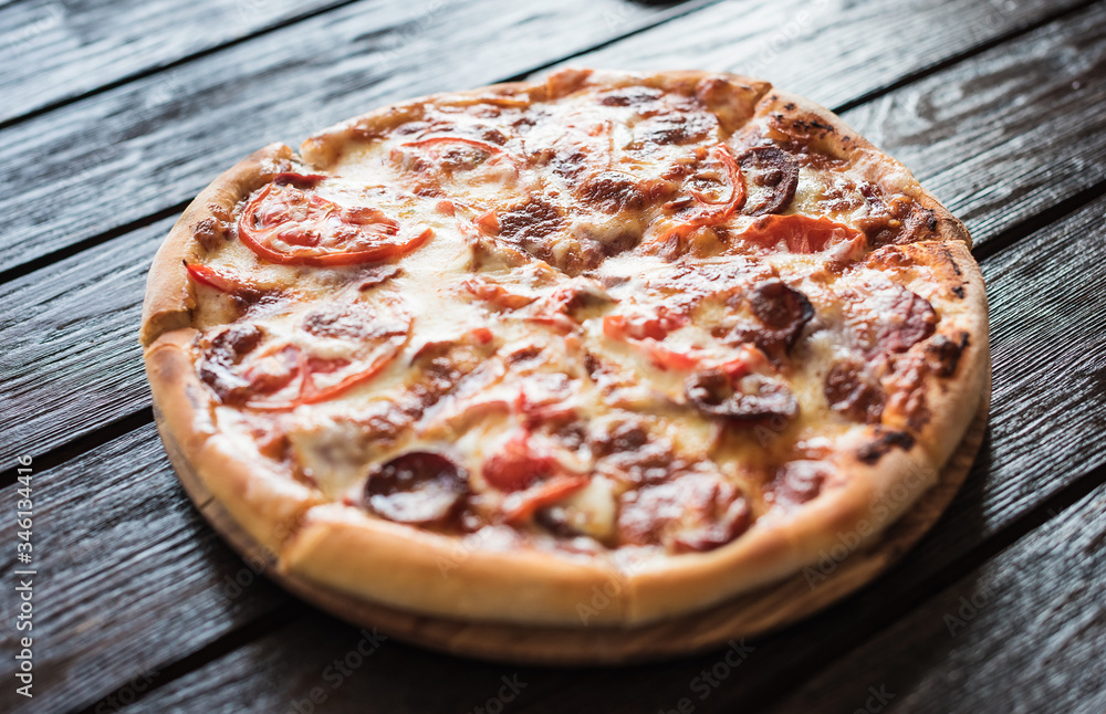 Big tasty sausage and tomatoes pizza.