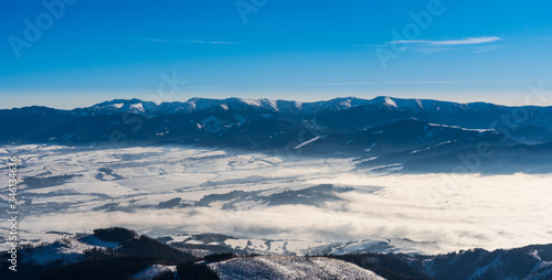Western Tatras mountains snowy with fog in the valley in winter, Slovakia Velky Choc 12.1.2020