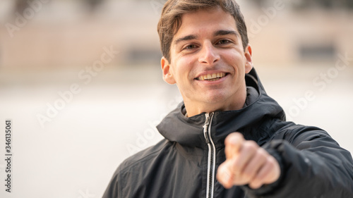 smiling man pointing at you with hand, sport
