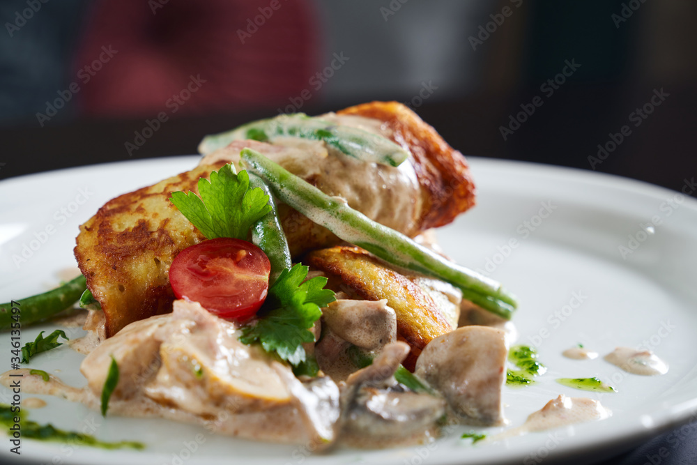 Dish with hash brown, vegetables and chicken. Dish with hash brown, vegetables and chicken.