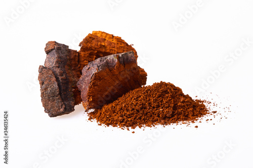 Natural Chaga mushroom pieces isolated on white background. A pile of chopped chaga mushroom, close up. Inonotus Obliquus. 