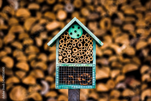 Rustic shelter for mason bees - DIY hive (bee house) made of natural materials, traditional design. Symbol of eco friendly beekeeping photo