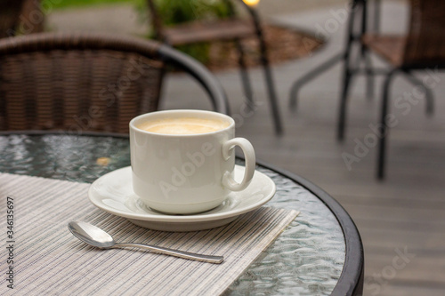 Mug of coffee in a summer cafe. Luxury rest.