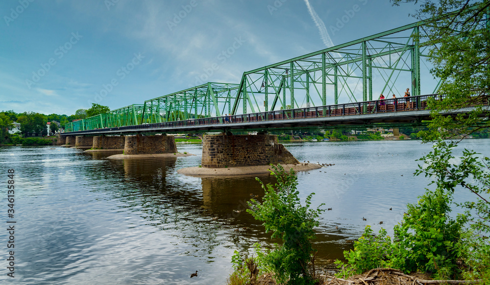 The New Hope-Lambertville Bridge over the Delaware River. Border between New Jersey and Pennsylvania. Bright day. The New Hope-Lambertville Bridge over the Delaware River. Border between New Jersey and Pennsylvania. Bright day.