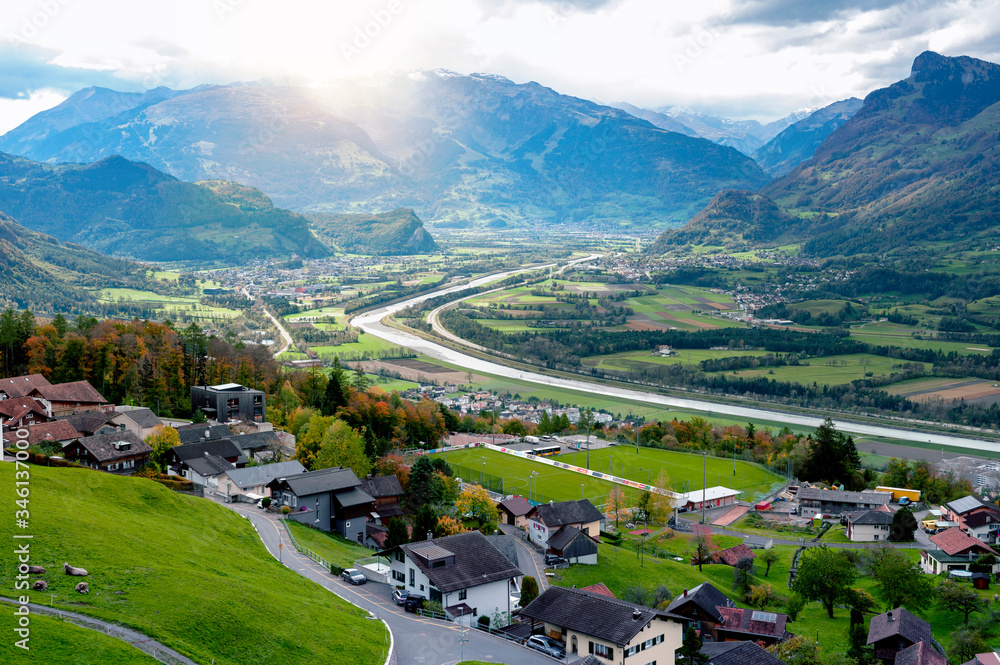 Scenic aerial view of hillside villages in Triesenberg and the river Rhine, natural border of Liechtenstein, an alpine country in central Europe, to Switzerland