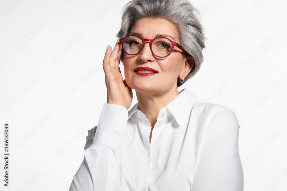 Fashion stylish mature woman in eyewear looking at camera 