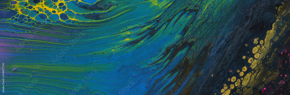 art photography of abstract marbleized effect background. Black, yellow, green and blue creative colors. Beautiful paint