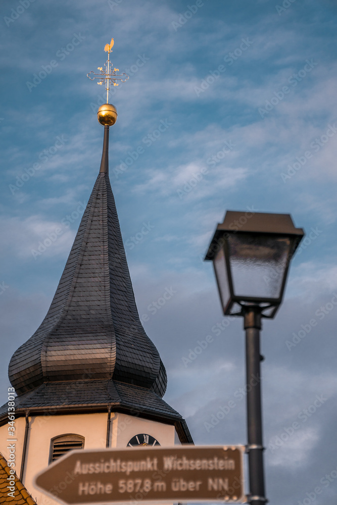 Church tower and Lamp with a street sign