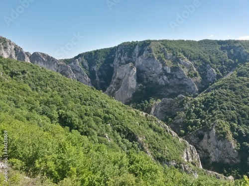 green rocky mountains in spring season on sunny day