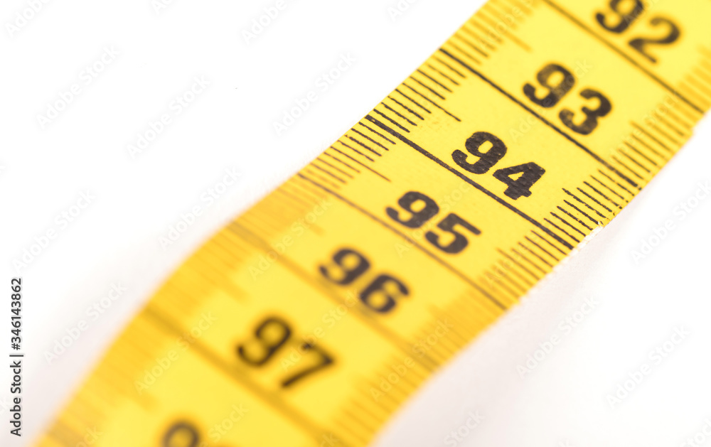 Close-up of a yellow measuring tape isolated on white - 94 Close-up of a yellow measuring tape isolated on white - 94