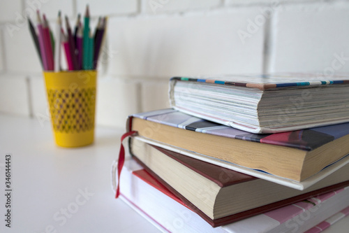 Study. Back to school. School supplies on a white background. Pencils, books, a globe.