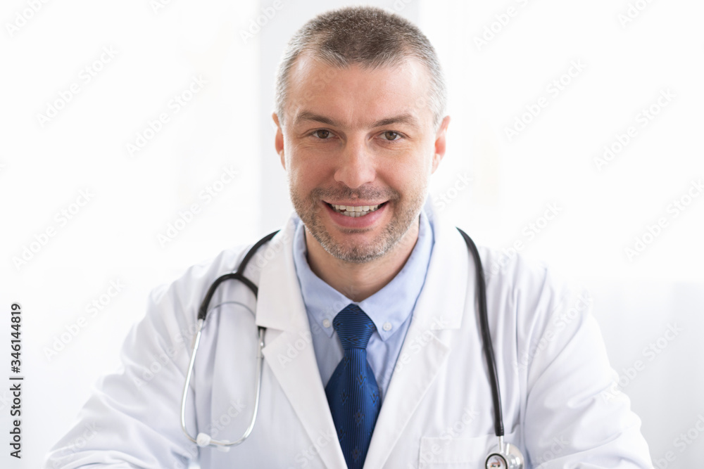 Portrait of mature doctor looking to camera Portrait of mature doctor looking to camera