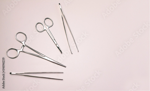 
Surgical instrument (clamps, tweezers, scissors) on a white background. Copy space. photo