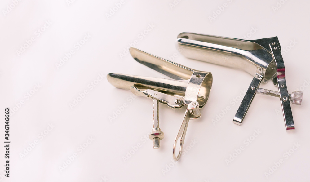 Two different gynecological mirrors on a white background. Copy space Gynecological examination instrument. Two different gynecological mirrors on a white background. Copy space Gynecological examination instrument.