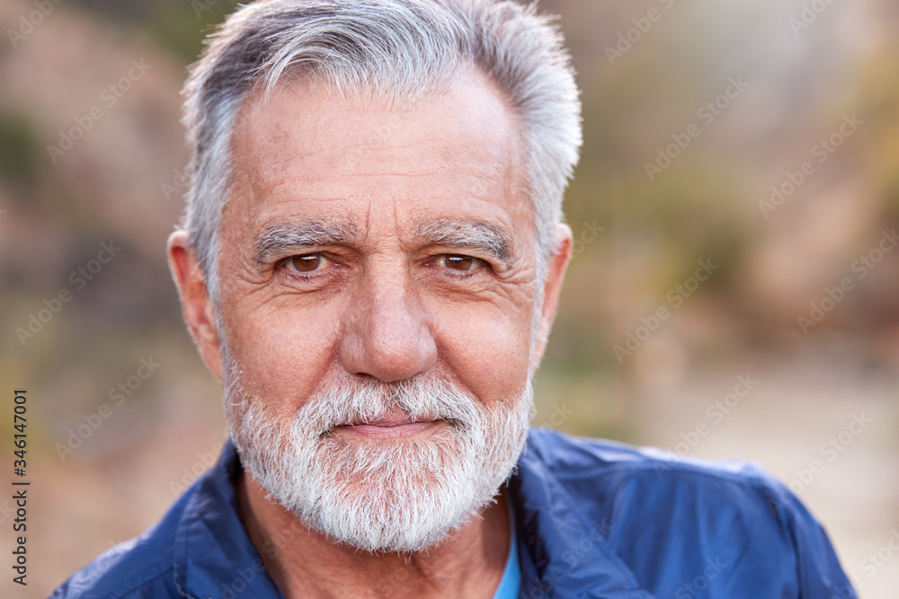 Outdoor Portrait Of Serious Hispanic Senior Man With Mental Health Concerns