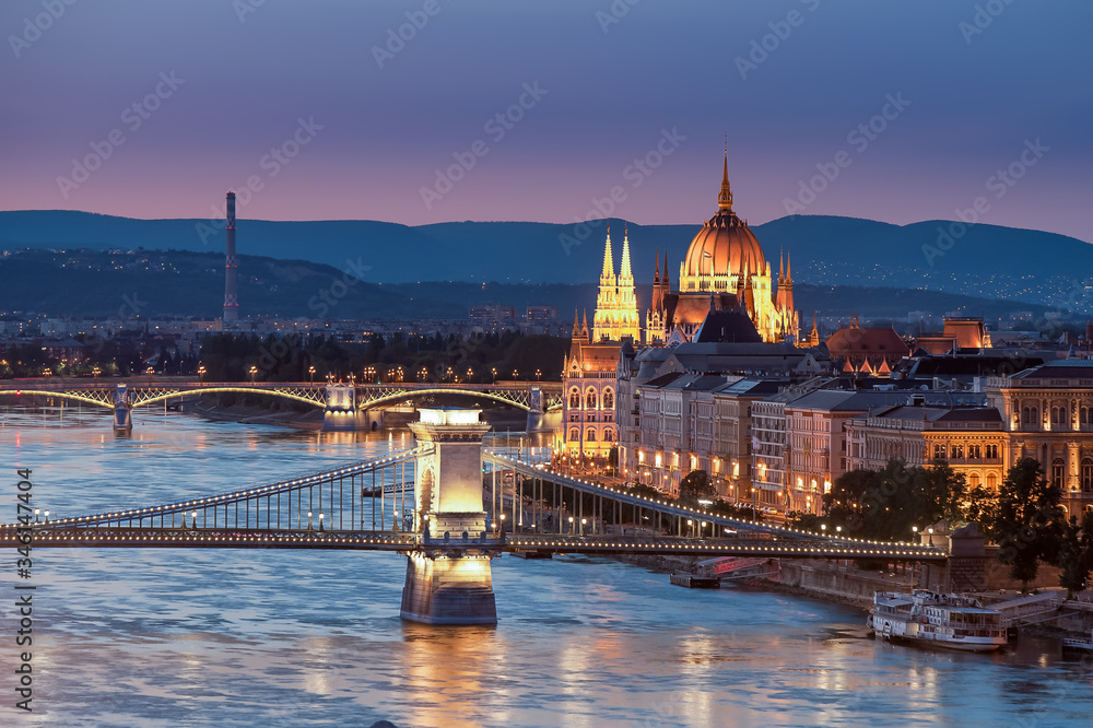 Hungary Budapest. Amazing photo about the Chain bridge and Danube river with Margaret bridge and cupola of Hungarian parliament historical building in evening time.