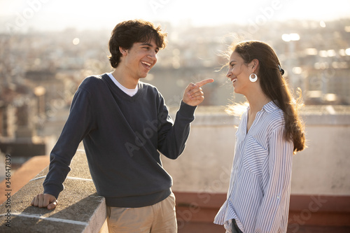Two young men talking on the rooftop