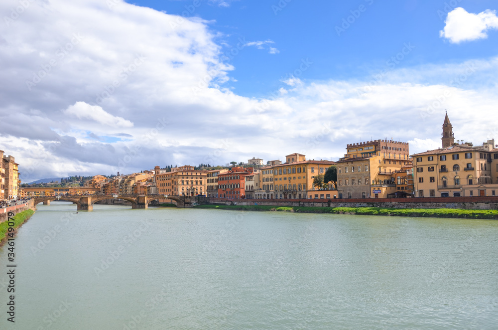Cityscape of Florence, Tuscany, Italy. Historical center located along the Arno river. Blue sky and clouds over the Italian city. Horizontal photo.