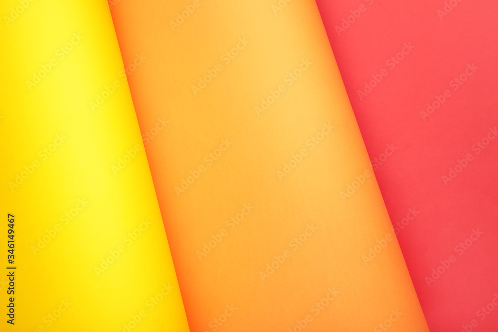 Color papers flat composition background with yellow, orange and red color