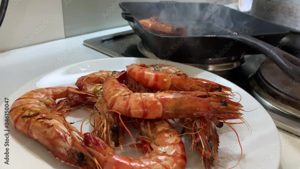 Slow-motion of grilling prawn or shrimp on ignited pan. Homemade cooking. Slow-motion of grilling prawn or shrimp on ignited pan. Homemade cooking.