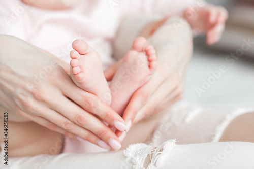 Close up still of baby s feet. Little toes in mother s hands. Baby concept. Maternity care.