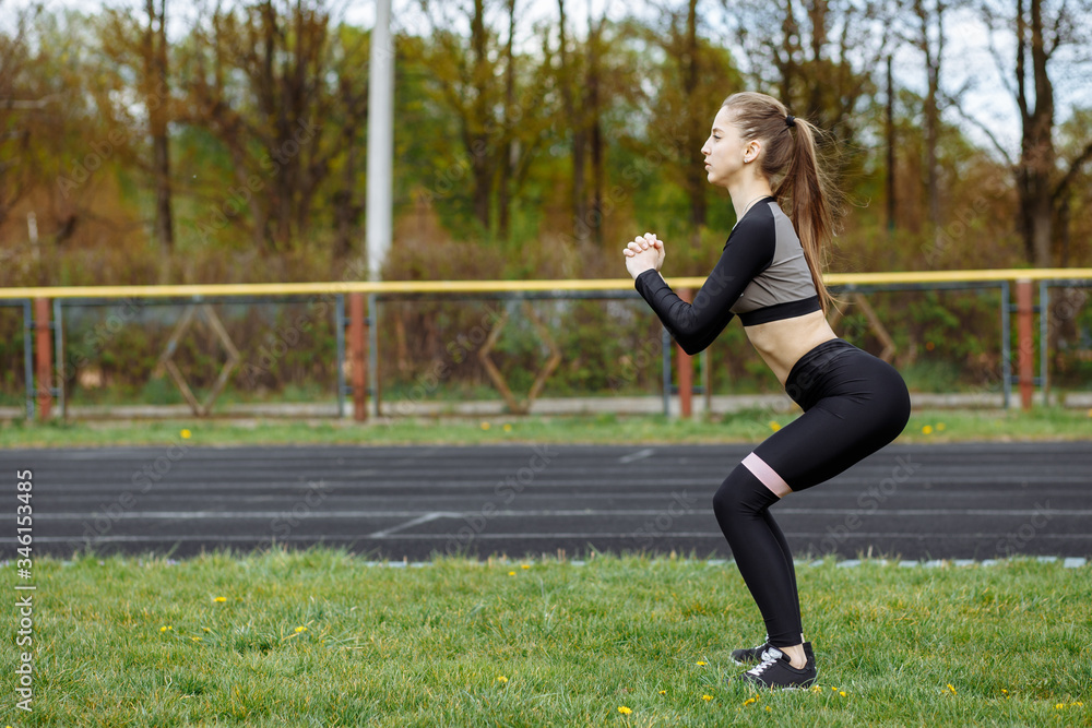 beautiful girl is workout with fitness gum,rubber bands on the street of the stadium beautiful girl is workout with fitness gum,rubber bands on the street of the stadium