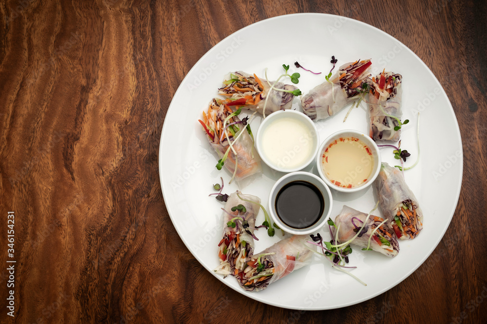 asian fresh vegetable vegan spring rolls with sauces in vietnam. asian fresh vegetable vegan spring rolls with sauces in vietnam.
