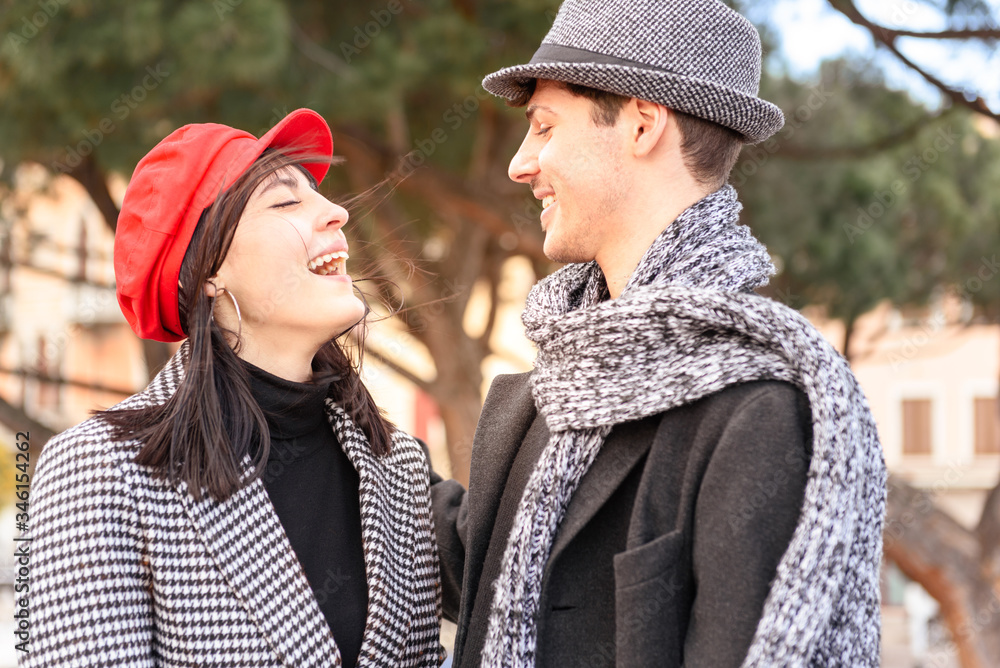Fototapeta premium Handsome man and pretty woman. Portrait of beautiful couple. Beautiful girl with red hat.