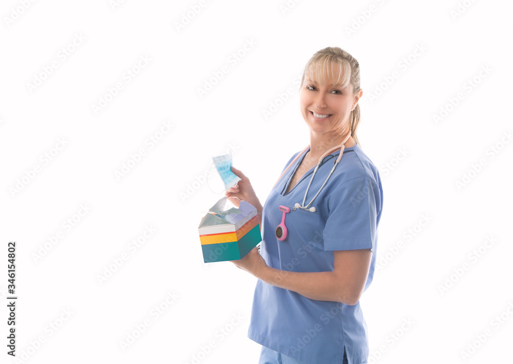 Smiling nurse holding a box of surgical medical masks or much needed PPE Smiling nurse holding a box of surgical medical masks or much needed PPE
