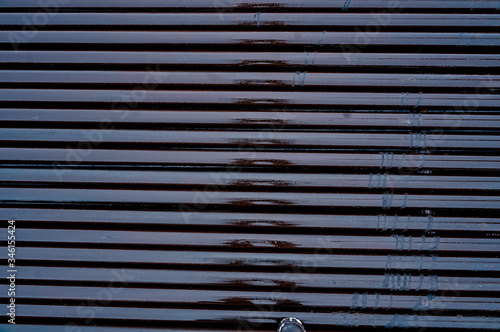 Texture oil drill pipe. Rusty drill pipes were drilled in the well section. Downhole drilling rig.  View of the shell of drill pipes laid in courtyard of the oil and gas warehouse photo