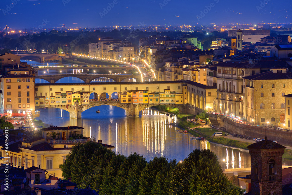 Night view of the River Arno and famous bridge Ponte Vecchio. Beautiful city night lights in Florence, Italy