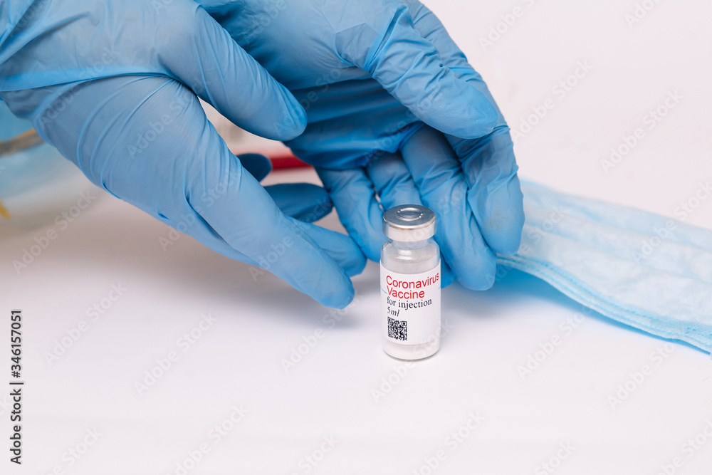 Coronavirus vaccine. Doctor with a vaccine. Hands holding a coronavirus vaccine ampoule, Covid-19 Coronavirus vaccine. Doctor with a vaccine. Hands holding a coronavirus vaccine ampoule, Covid-19