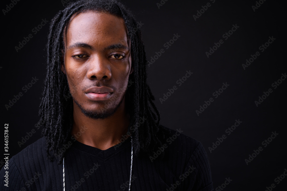 Face of young handsome African man with dreadlocks Face of young handsome African man with dreadlocks