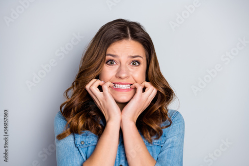 Closeup photo of attractive lady watch news listen bad mood not believe eyes corona virus disease spread infection biting fingers wear casual denim shirt isolated grey color background