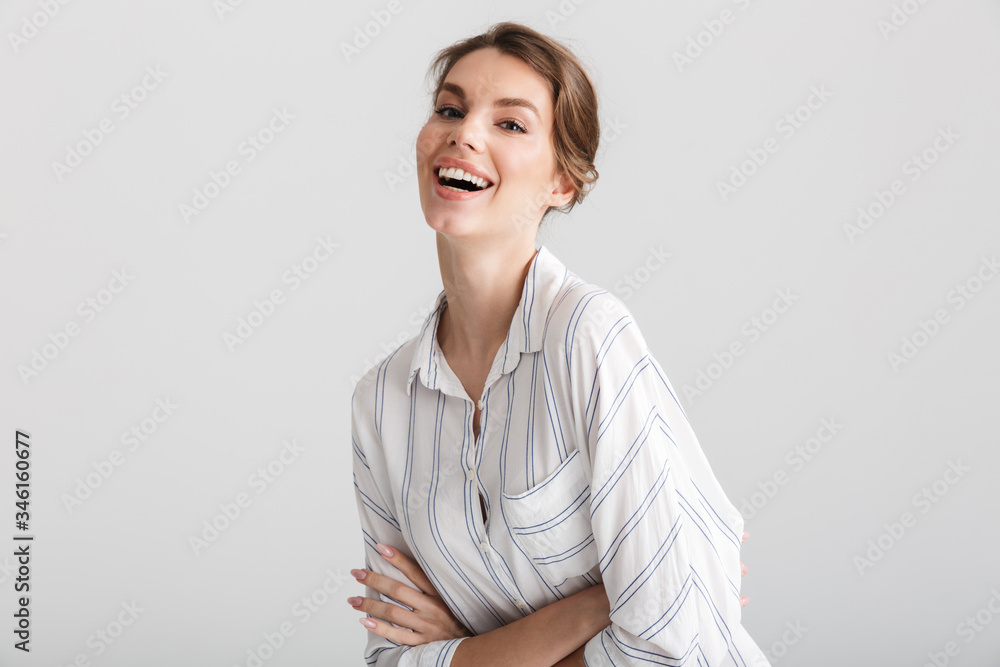Image of cheerful caucasian woman posing and laughing at camera Image of cheerful caucasian woman posing and laughing at camera