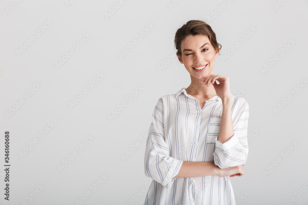 Image of cheerful nice woman smiling and winking on camera Image of cheerful nice woman smiling and winking on camera