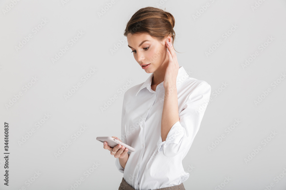Image of thinking beautiful woman typing on mobile phone Image of thinking beautiful woman typing on mobile phone