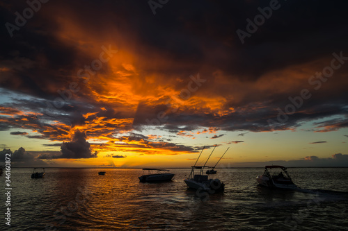 fabulous view of the sunset in Mauritius. Fishing boats on the background of mountains and the setting sun