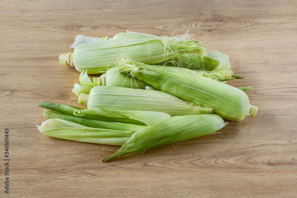Mature corn on the cob  wooden background, flat lay, top view