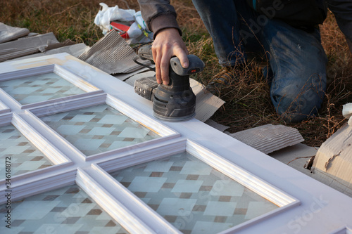 restoration of old wooden doors, surface cleaning with a grinding tool, preparation for painting