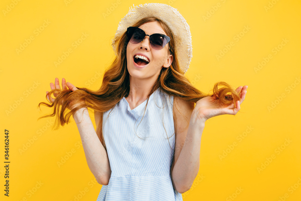 happy girl in summer hat wearing sunglasses in summer clothes smiling on isolated yellow background happy girl in summer hat wearing sunglasses in summer clothes smiling on isolated yellow background