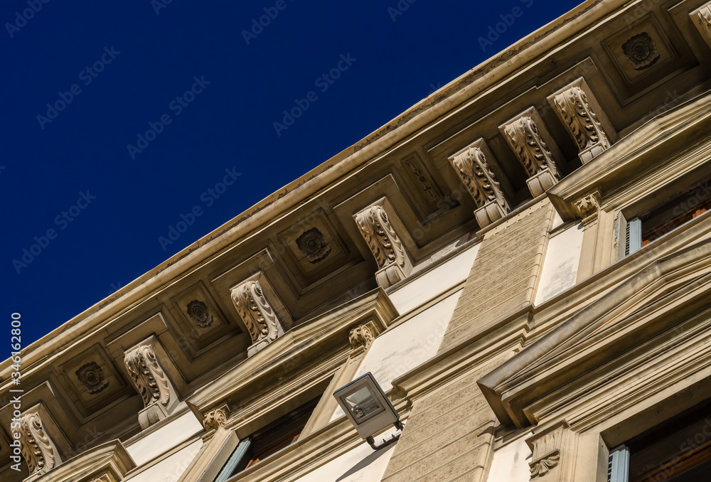 Decorated structural stone corbels in a row under the roof of beautiful italian old palace Decorated structural stone corbels in a row under the roof of beautiful italian old palace