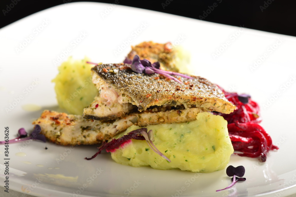 Fine dining Seabass fillets on carrot potato purree and spices Fine dining Seabass fillets on carrot potato purree and spices