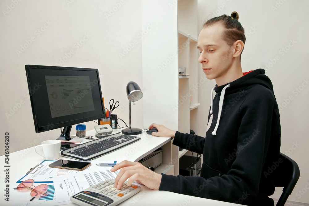 A young specialist works with financial documents A young specialist works with financial documents